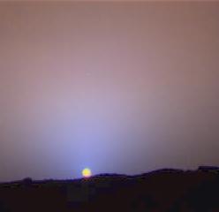 A Martian sunset photographed by Mars Pathfinder in 1997 — the sky around the setting Sun glows blue.