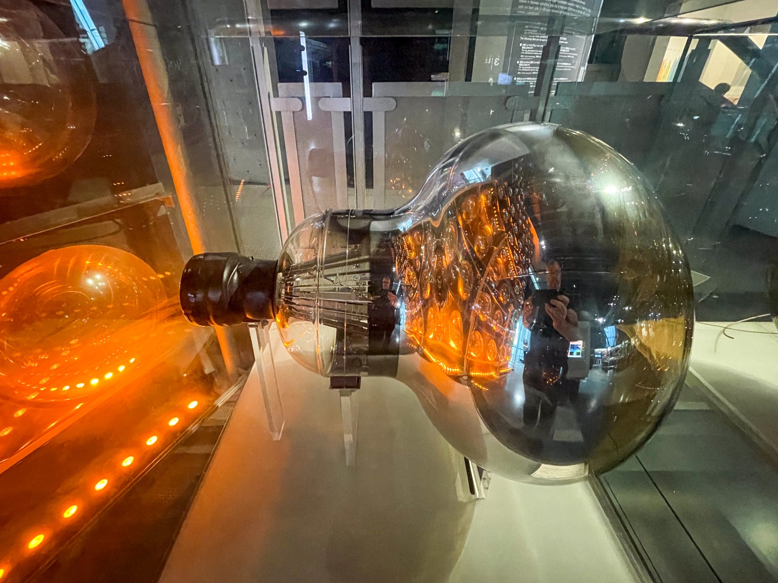 A large photomultiplier tube shaped like a glass bulb, on display