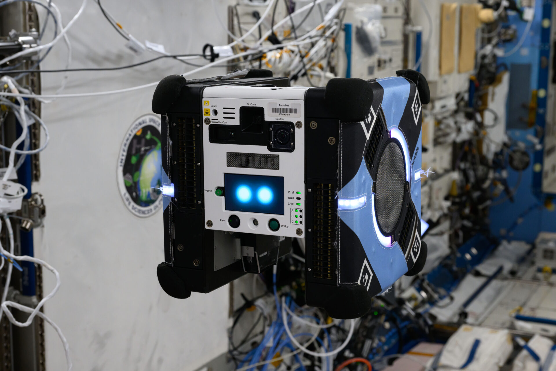 A cube-shaped robot called Astrobee free-flying inside the International Space Station