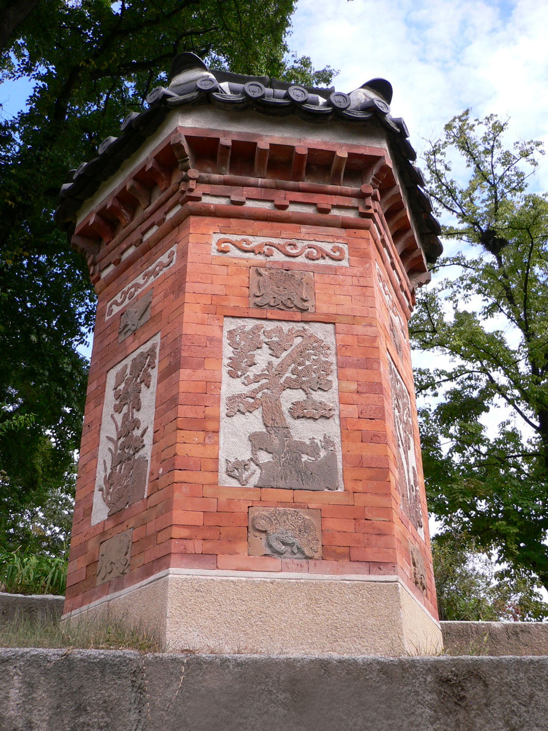 An ornate hexagonal red-brick chimney of Amisan at Gyeongbokgung, carved with longevity motifs