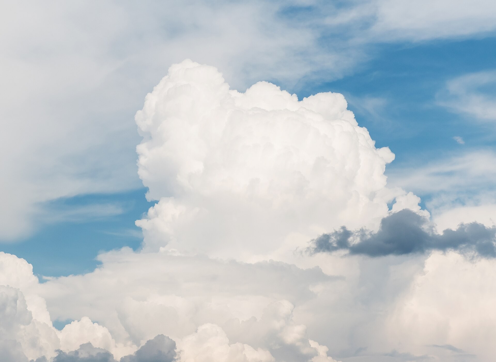 A towering cumulus cloud billowing upward