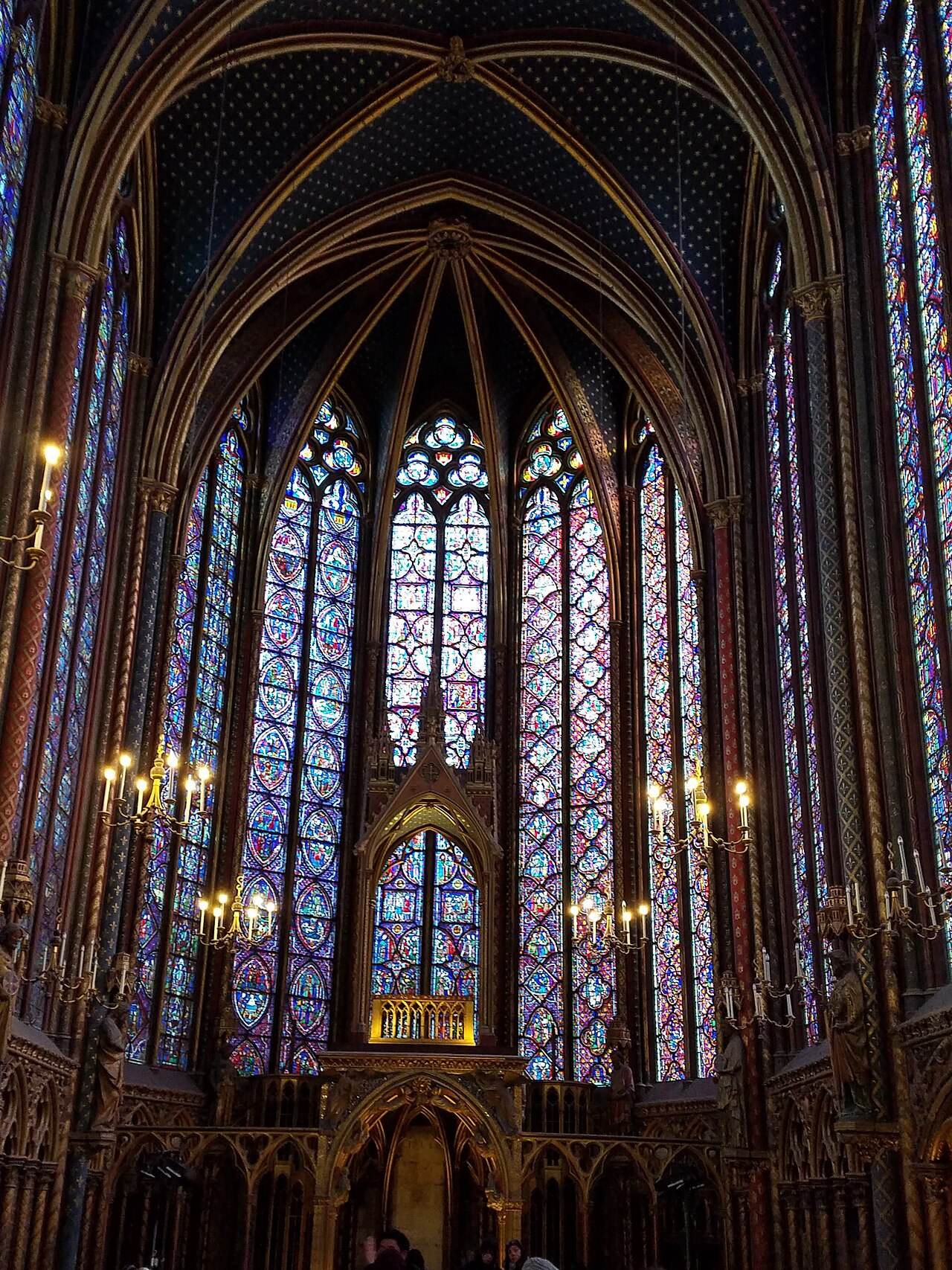 Stained-glass windows inside Sainte-Chapelle. Broad color areas and their dividing lines form a picture at a distance.