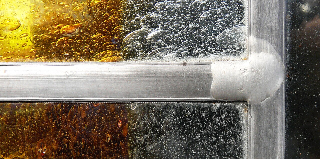 Close-up of a soldered metal junction, showing that the boundaries between pieces are physical assembly components.